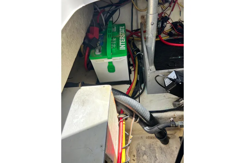 Slide: The Image of Battery compartment of a 2015 Monterey 268SS Super Sport boat, featuring an Interstate battery. - 66