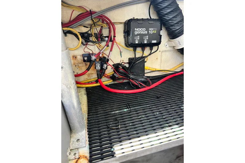 Slide: The Image of Electrical wiring and NOCO Genius charger in a 2015 Monterey 268SS Super Sport boat. - 67