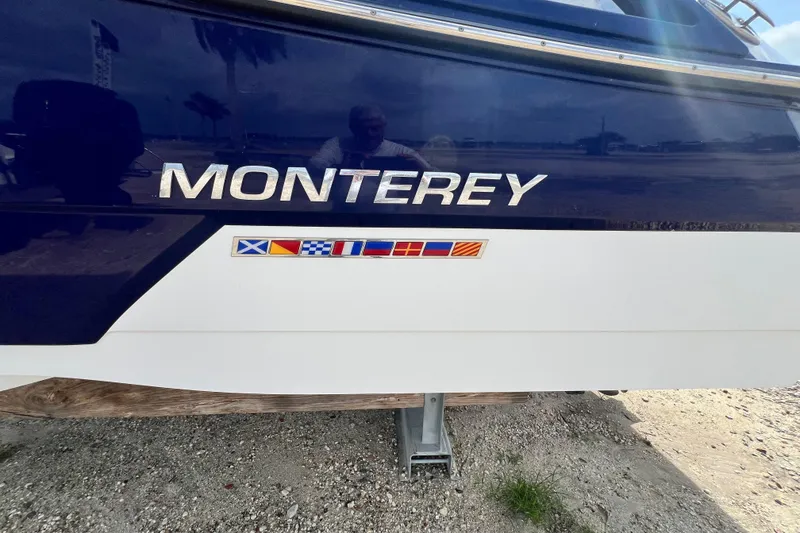 Slide: The Image of 2015 Monterey 268SS Super Sport boat with nautical flags on the hull. - 9