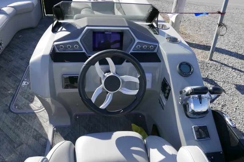 Slide: The Image of 2019 Manitou 25 Encore RF boat dashboard with steering wheel and controls. - 10