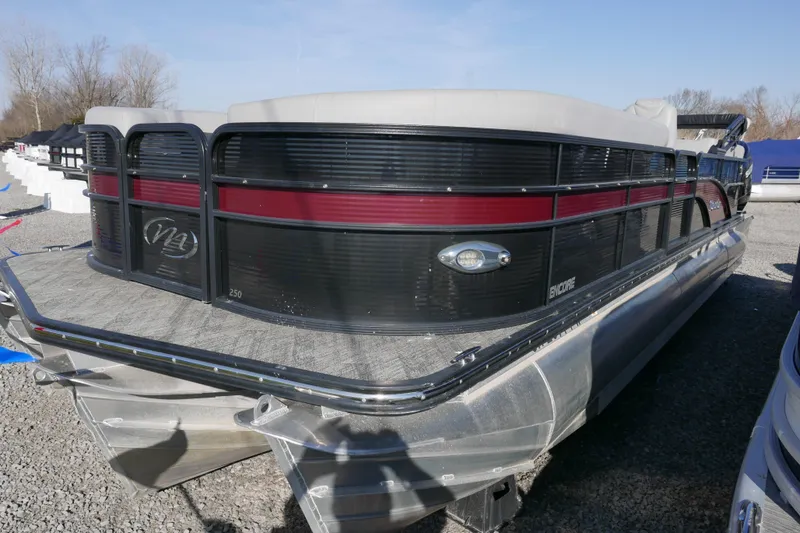 Slide: The Image of 2019 Manitou 25 Encore RF pontoon boat with sleek black and red design. - 2