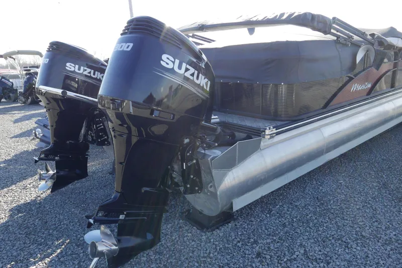 Slide: The Image of 2019 Manitou 25 Encore RF pontoon boat with dual Suzuki outboard motors. - 3