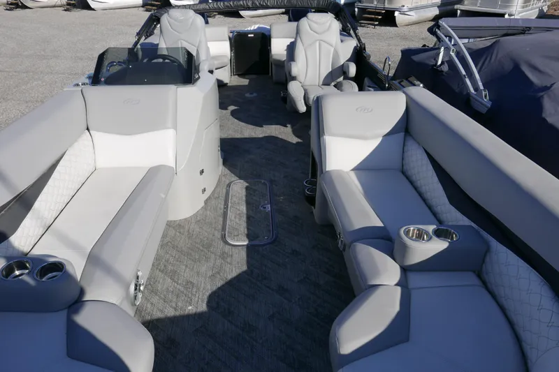 Slide: The Image of 2019 Manitou 25 Encore RF pontoon boat interior with gray seating and cup holders. - 5