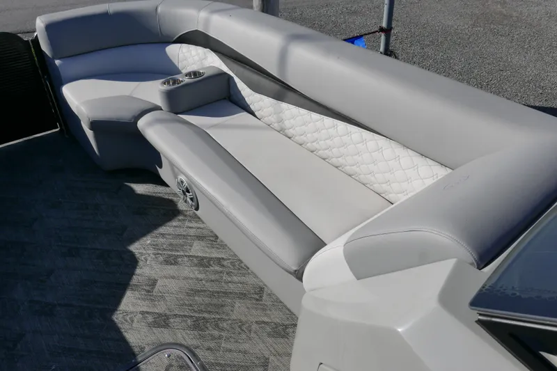 Slide: The Image of 2019 Manitou 25 Encore RF boat interior with gray seating and cup holders. - 7