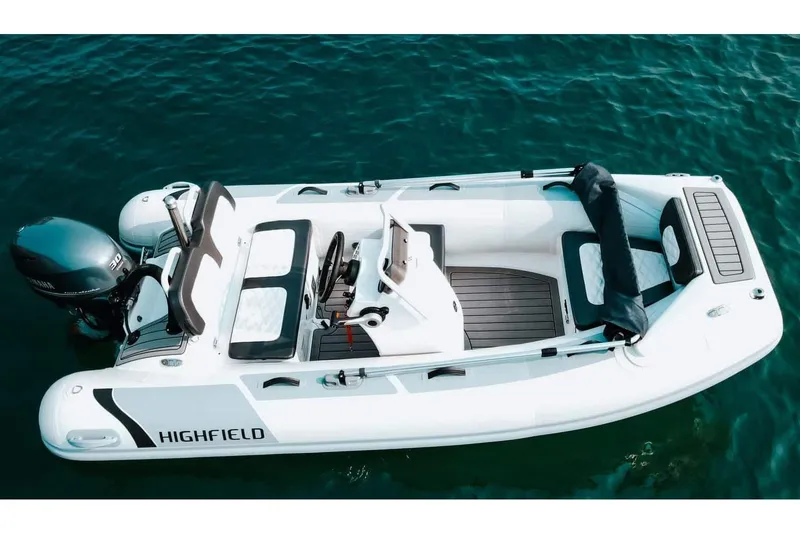 Slide: The Image of Manufacturer Provided Image: 2025 Highfield Sport 360 inflatable boat on clear blue water. - 2