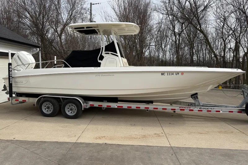 The Image of 2022 Boston Whaler 270 Dauntless boat on trailer, parked outdoors. - 0