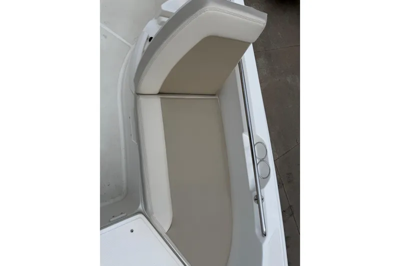 Slide: The Image of 2022 Boston Whaler 270 Dauntless boat seat with beige upholstery and stainless steel rail. - 12
