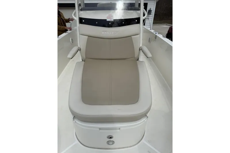 Slide: The Image of 2022 Boston Whaler 270 Dauntless boat seat with beige cushion and storage compartment. - 13