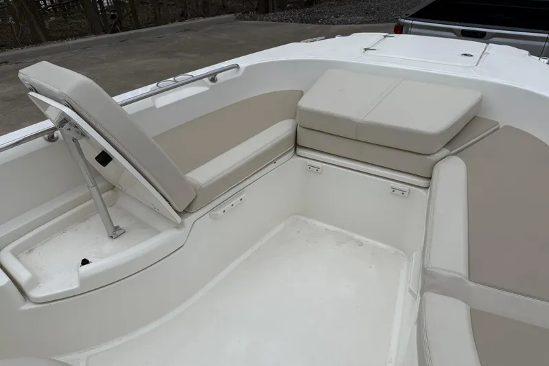 Slide: The Image of 2022 Boston Whaler 270 Dauntless boat interior with cushioned seating and storage. - 14