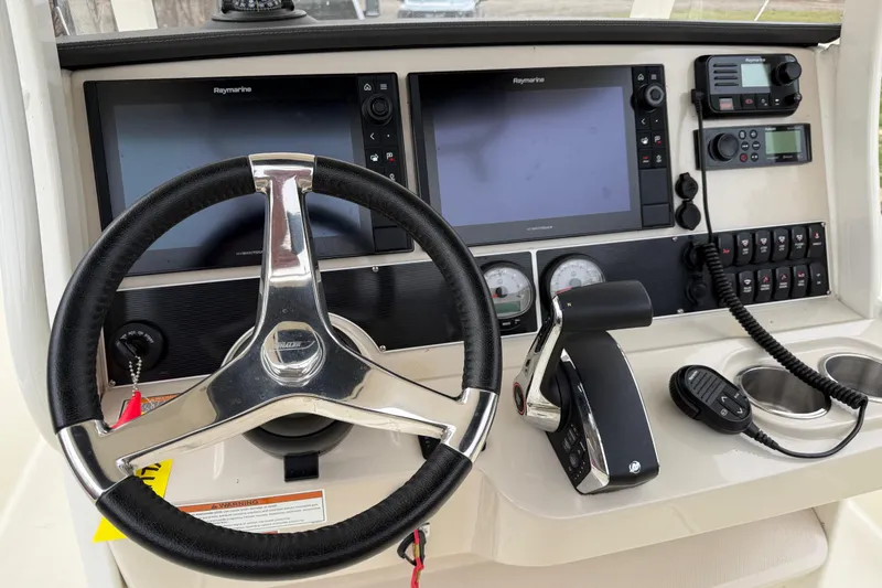 Slide: The Image of Steering console of 2022 Boston Whaler 270 Dauntless with navigation screens and controls. - 15