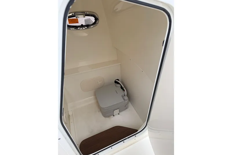 Slide: The Image of 2022 Boston Whaler 270 Dauntless interior with compact marine toilet. - 17