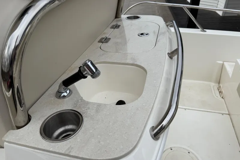 Slide: The Image of Boston Whaler 270 Dauntless 2022 boat sink and faucet detail. - 19