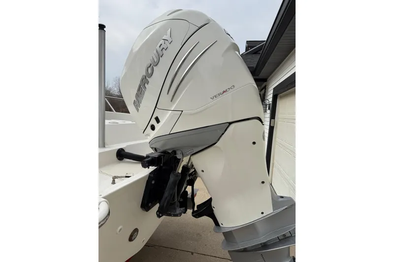 Slide: The Image of 2022 Boston Whaler 270 Dauntless with Mercury Verado outboard motor in driveway. - 2