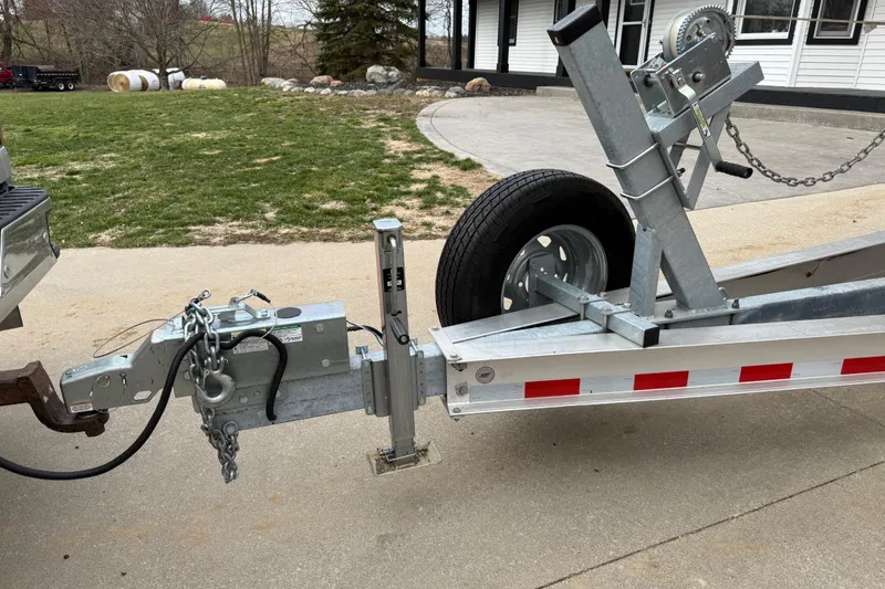 Slide: The Image of Trailer hitch setup for 2022 Boston Whaler 270 Dauntless boat, parked on driveway. - 6