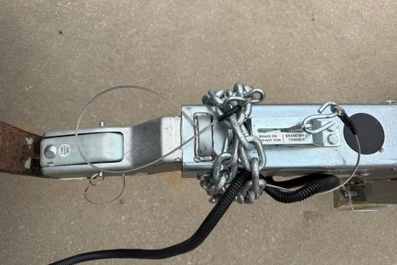 Slide: The Image of Trailer hitch with chains and brake labels for 2022 Boston Whaler 270 Dauntless. - 7