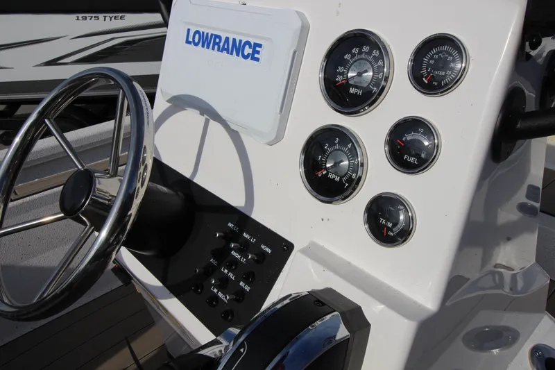 Slide: The Image of 2023 Vexus AVX2180CC boat dashboard with gauges and Lowrance display. - 10