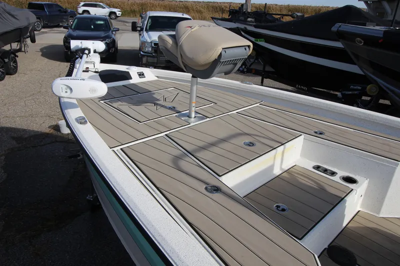 Slide: The Image of 2023 Vexus AVX2180CC boat with sleek deck design, parked outdoors. - 15