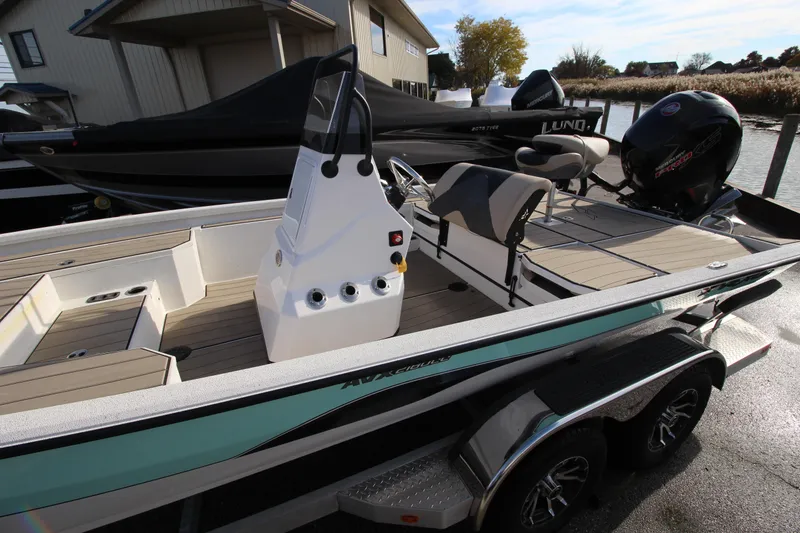 Slide: The Image of 2023 Vexus AVX2180CC boat with sleek design and modern features docked outdoors. - 4