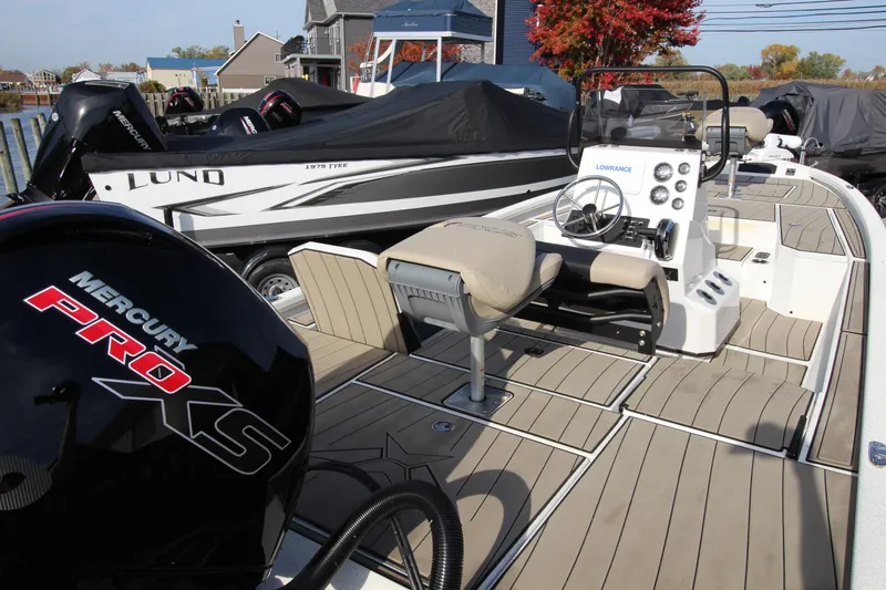 Slide: The Image of 2023 Vexus AVX2180CC boat with Mercury Pro XS engine, docked near other boats. - 5