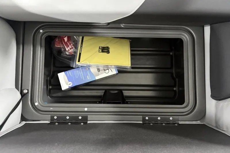 Slide: The Image of Storage compartment in 2026 Sun Tracker SportFish 20 DLX boat with manuals and accessories. - 23