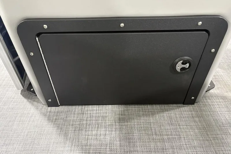 Slide: The Image of Storage compartment on 2026 Sun Tracker SportFish 20 DLX boat, featuring a secure latch. - 28