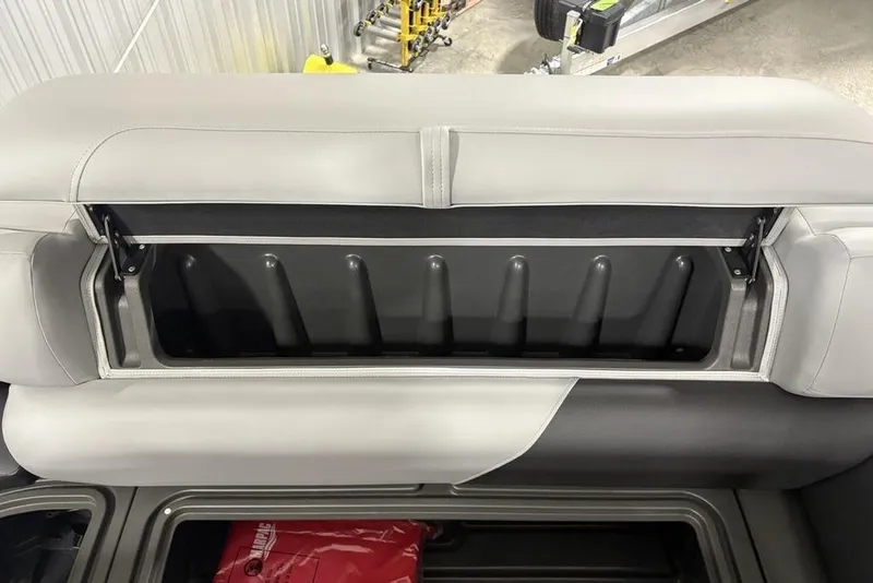 Slide: The Image of 2026 Sun Tracker SportFish 20 DLX boat seat storage compartment, open and empty. - 5