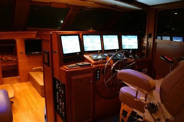 Slide: The Image of Luxurious 2009 Saint Custom Boats Model 65 Commuter helm with advanced navigation screens. - 3