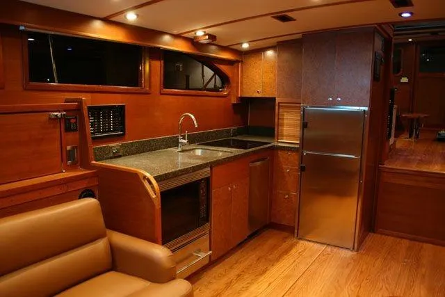 Slide: The Image of Luxurious interior of 2009 Saint Custom Boats Model 65 Commuter with modern kitchen amenities. - 5