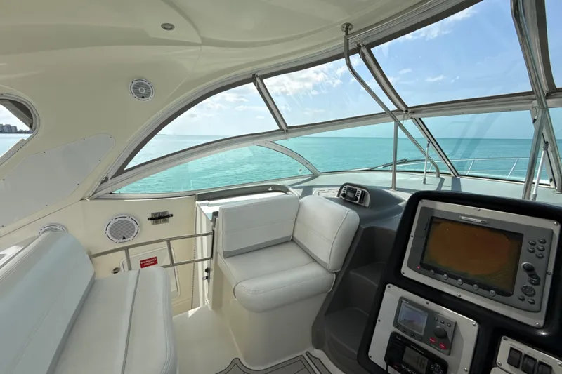 Slide: The Image of Interior view of 2006 Cruisers Yachts 420 Express helm with ocean backdrop. - 10