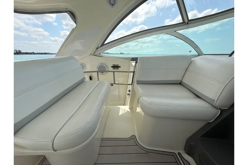 Slide: The Image of Interior of 2006 Cruisers Yachts 420 Express with white seating and panoramic windows. - 12