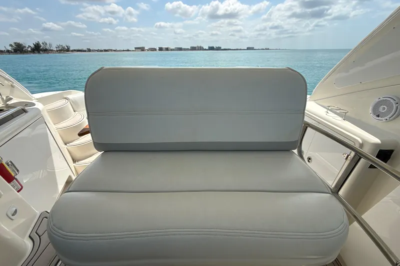 Slide: The Image of Luxury seating on 2006 Cruisers Yachts 420 Express, overlooking serene ocean waters. - 14