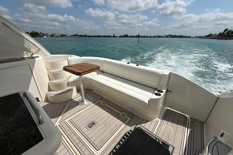 Slide: The Image of 2006 Cruisers Yachts 420 Express deck with seating, table, and ocean view. - 16
