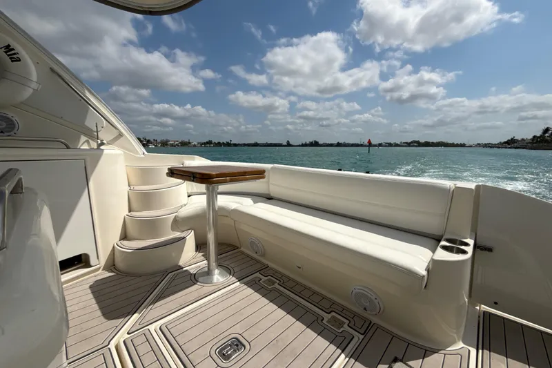 Slide: The Image of 2006 Cruisers Yachts 420 Express deck with seating, table, and ocean view. - 17
