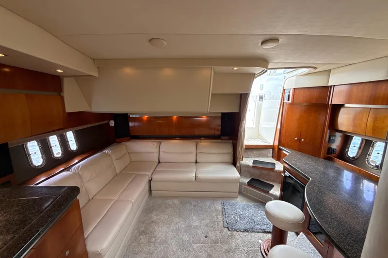 Slide: The Image of Luxurious interior of 2006 Cruisers Yachts 420 Express with leather seating and wooden cabinetry. - 26