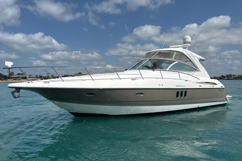Slide: The Image of 2006 Cruisers Yachts 420 Express on calm blue water under a partly cloudy sky. - 39