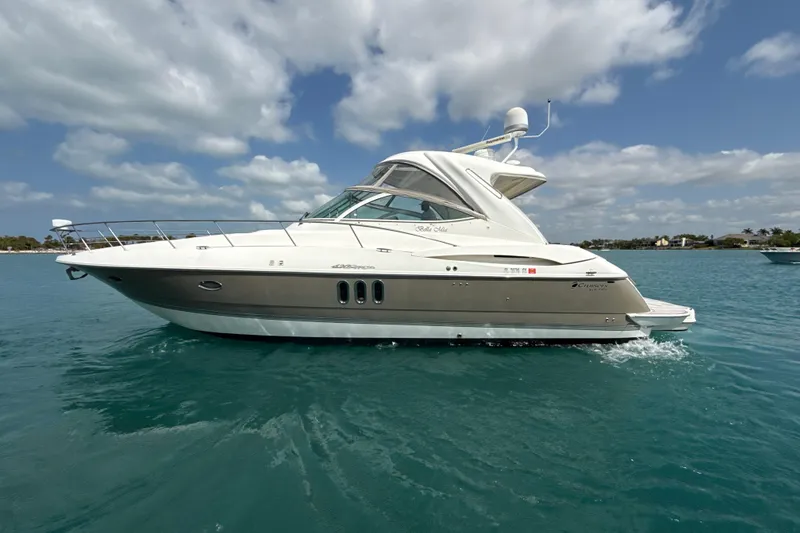 Slide: The Image of 2006 Cruisers Yachts 420 Express on clear blue water under a partly cloudy sky. - 40