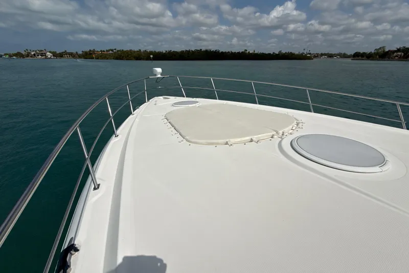 Slide: The Image of 2006 Cruisers Yachts 420 Express bow view on calm water under cloudy sky. - 46