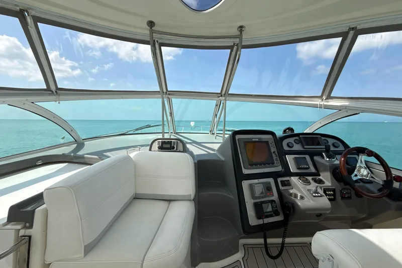 Slide: The Image of Interior view of 2006 Cruisers Yachts 420 Express helm with ocean backdrop. - 6