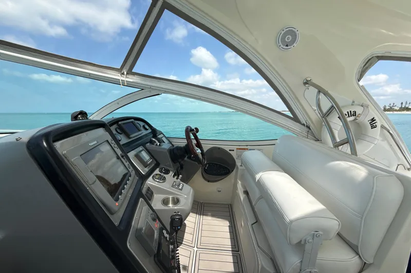 Slide: The Image of 2006 Cruisers Yachts 420 Express helm with ocean view, featuring modern navigation equipment. - 7