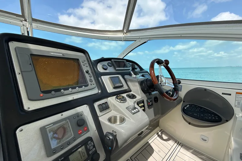 Slide: The Image of Cockpit view of 2006 Cruisers Yachts 420 Express with navigation equipment and ocean backdrop. - 8
