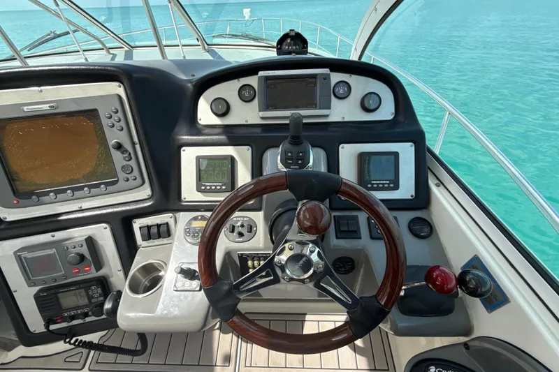 Slide: The Image of Cockpit of 2006 Cruisers Yachts 420 Express with steering wheel and navigation instruments. - 9