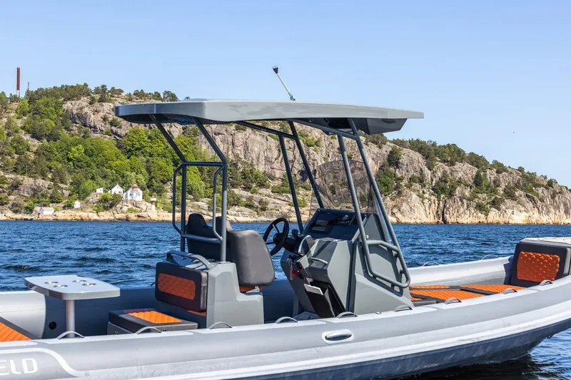 Slide: The Image of Manufacturer Provided Image: 2025 Highfield Sport 760 boat on scenic water with rocky shoreline backdrop. - 3