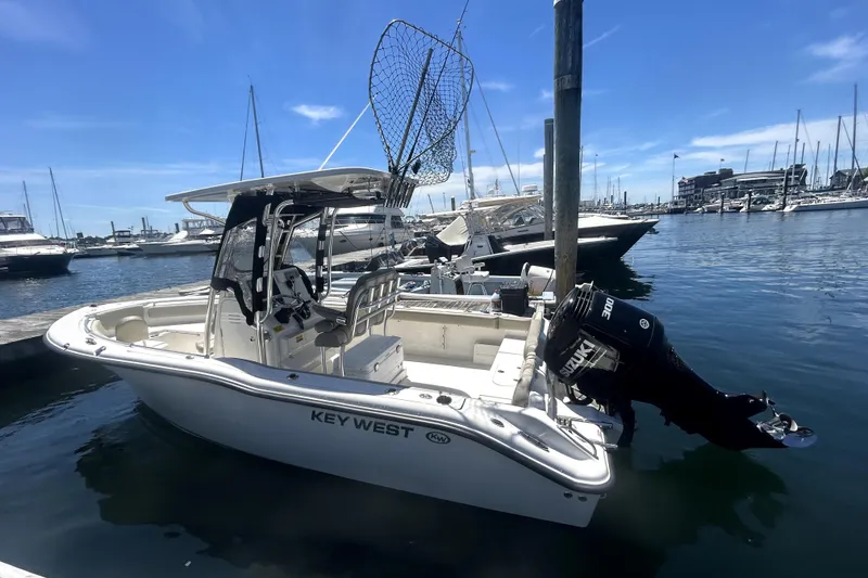 Slide: The Image of 2023 Key West 239 FS boat docked in a marina under a clear blue sky. - 10