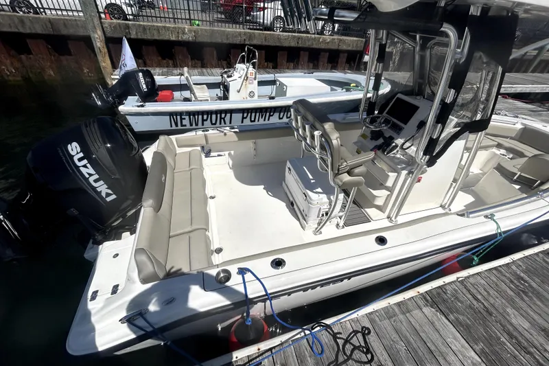 Slide: The Image of 2023 Key West 239 FS boat docked, featuring Suzuki outboard motor and spacious seating. - 12