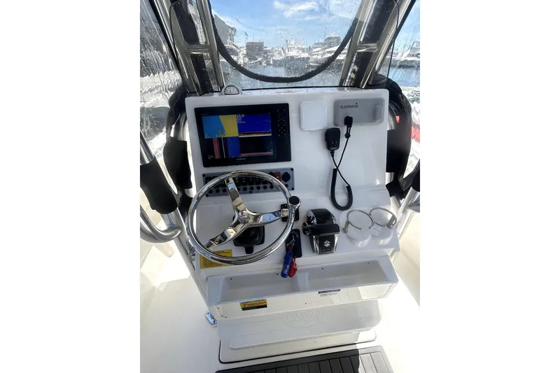 Slide: The Image of 2023 Key West 239 FS boat dashboard with Garmin navigation system and steering wheel. - 14