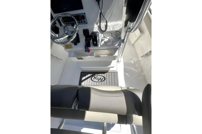 Slide: The Image of Interior view of 2023 Key West 239 FS boat cockpit with steering wheel and controls. - 16