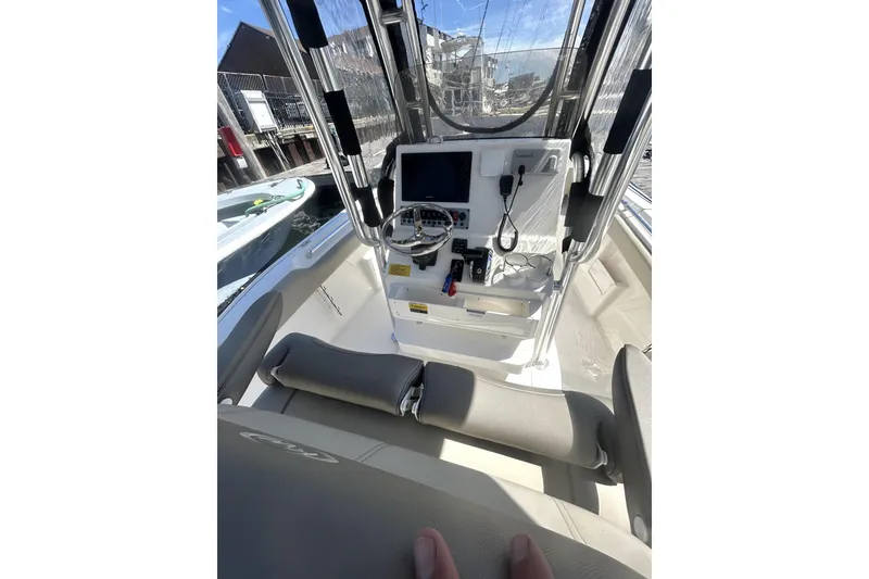 Slide: The Image of 2023 Key West 239 FS boat cockpit with steering wheel and navigation equipment. - 17