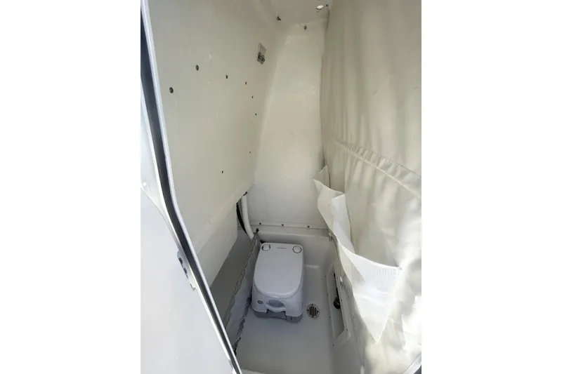 Slide: The Image of 2023 Key West 239 FS boat interior with compact marine toilet. - 19