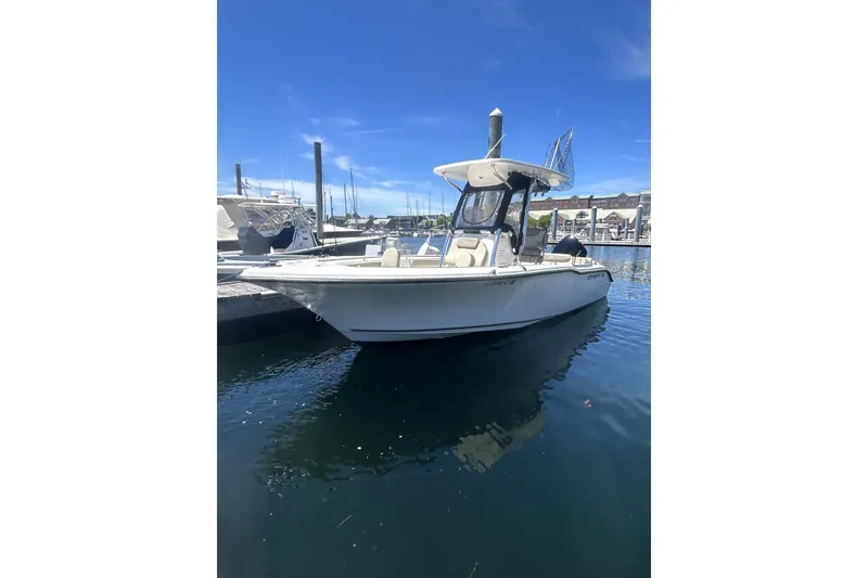 Slide: The Image of 2023 Key West 239 FS boat docked in a marina under clear blue skies. - 2