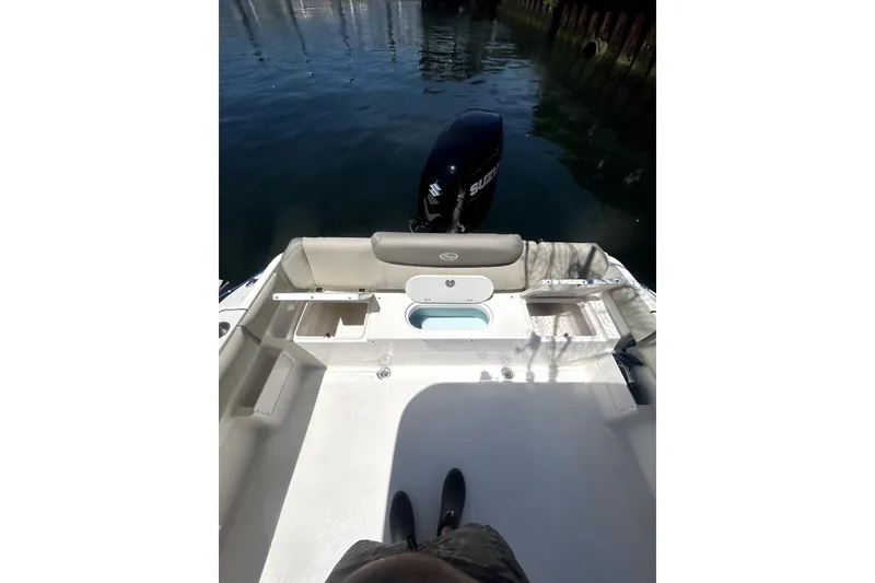Slide: The Image of 2023 Key West 239 FS boat deck with seating and outboard motor. - 20